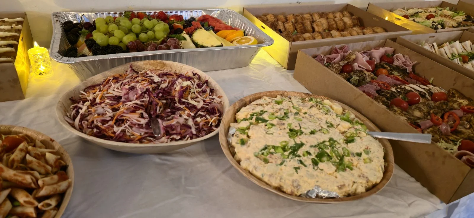 Full buffet spread across a long table at an indoor venue