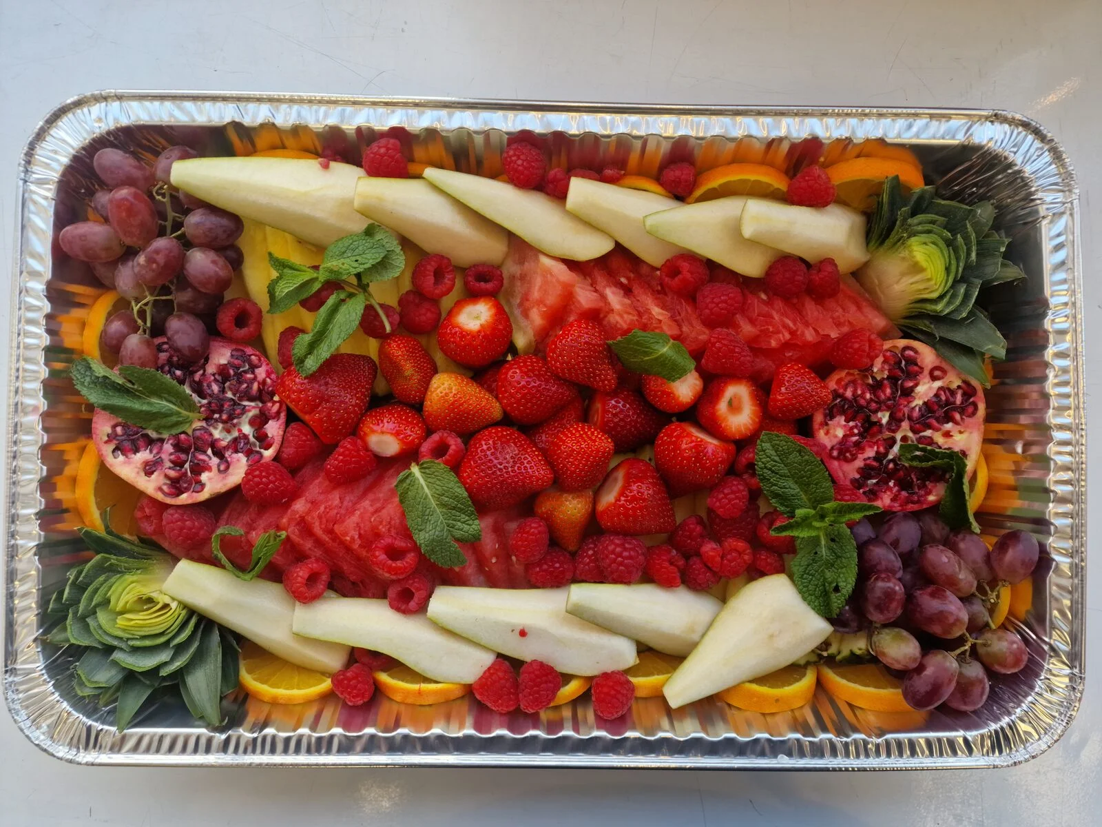 Close-up of strawberries, cherries, grapes and pomegranate on a fruit board