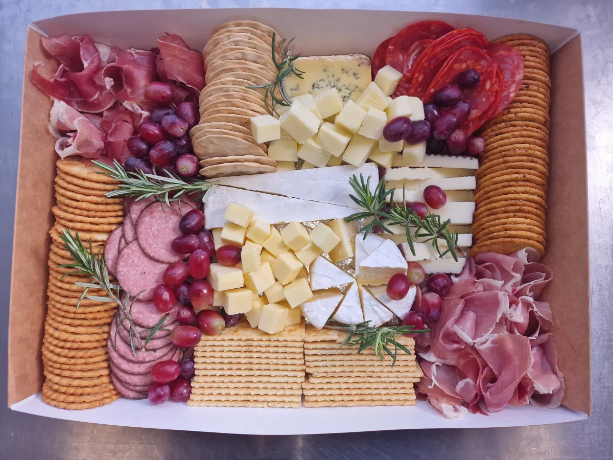 Large charcuterie box with salami roses, prosciutto, olives and grapes