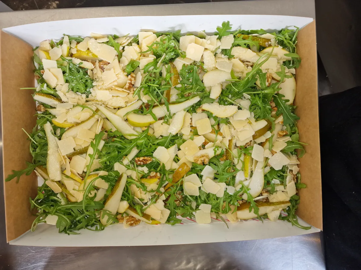 Rocket, pear and parmesan salad in a catering box
